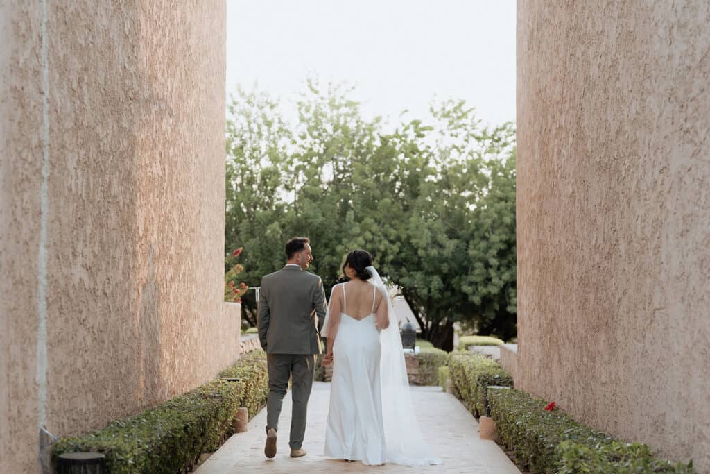 a man and woman walking down a path at palais paysan