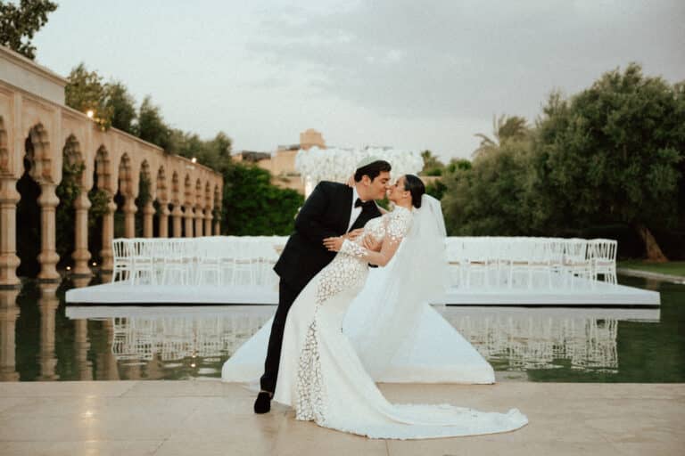 Charlotte and Kevin beside the arches and reflecting pools at Palais Namaskar after their wedding ceremony.